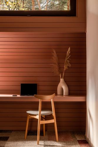 a table and a chair in a room with a window at Forest Hotel in Kraków