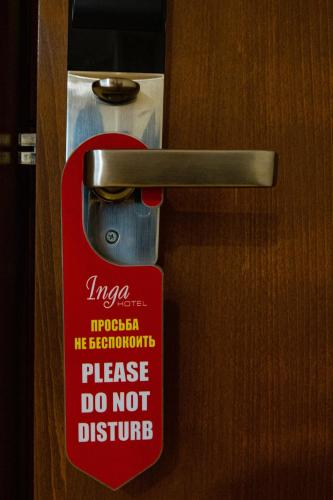 a sign on a door that says please do not disturb at Inga Hotel Yerevan in Yerevan