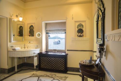 a bathroom with a sink and a large window at Taj Lake Palace Udaipur in Udaipur