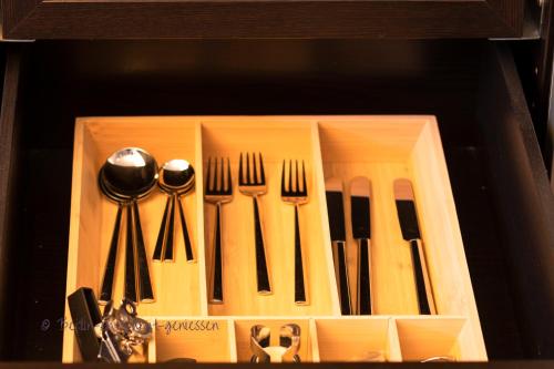 a wooden box with forks and knives and utensils at Berlin entspannt geniessen in Berlin