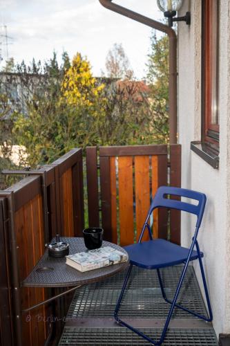a blue chair sitting on a table on a balcony at Berlin entspannt geniessen in Berlin