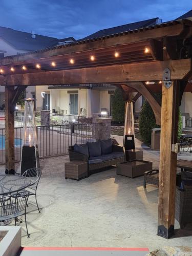 a wooden pergola with a couch on a patio at Club Hotel Nashville Inn & Suites in Nashville