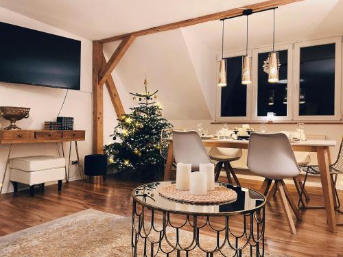 a living room with a christmas tree and a table at ALTE SCHULE WITTENBERG, 3 Ferienwohnungen für bis zu 12 Personen, an der Elbe, mit Garten in Lutherstadt Wittenberg