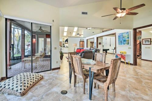 a dining room and living room with a table and chairs at Riverfront DeLand Home with Pool, Near Daytona! in DeLand