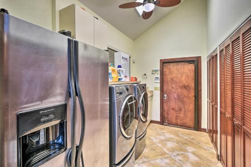 a kitchen with two washer and dryers and a refrigerator at Riverfront DeLand Home with Pool, Near Daytona! in DeLand
