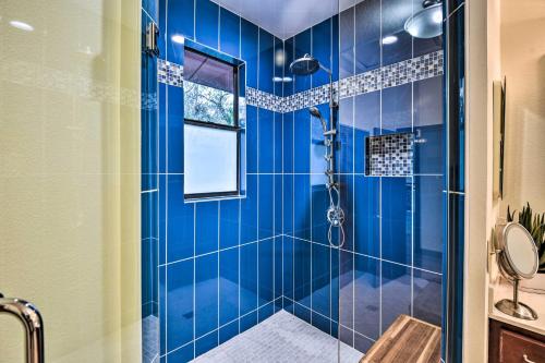 a blue tiled shower in a bathroom with a window at Riverfront DeLand Home with Pool, Near Daytona! in DeLand