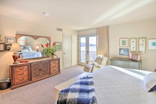 a bedroom with a bed and a large mirror at Lakefront Hot Springs Condo with Boat Dock! in Hot Springs