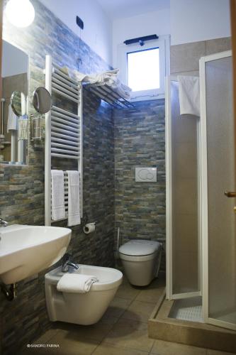 a bathroom with a sink and a toilet and a shower at Accord Le Rose in Palagiano
