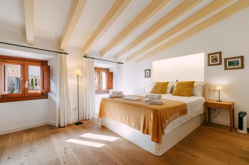 a bedroom with a large bed and a window at Casa Rei Sanxo, 8A in Valldemossa
