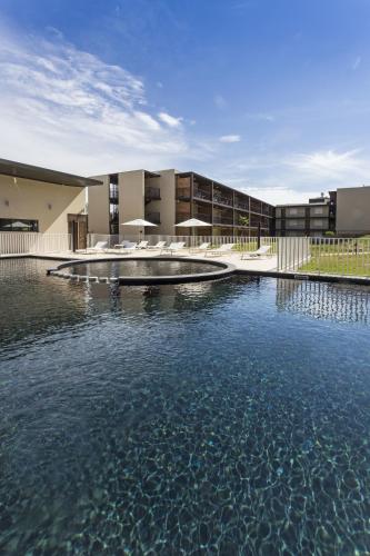 a pool of water in front of a building at Residhotel Résidence Pont du Gard in Remoulins