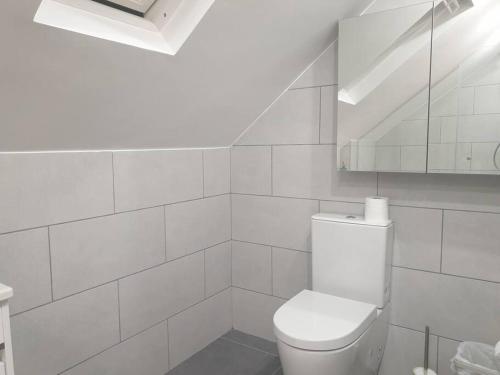 a white bathroom with a toilet and a staircase at New - Bright London studio loft king bed apartment in quiet street near parks 1074 Lo in London