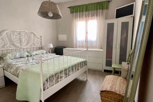 1 dormitorio con cama blanca y ventana en Villa Mandrés. Casa con jardín y piscina. Proximo a Puy Du Fou., en Totanés