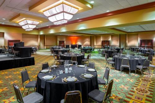 a banquet hall with round tables and chairs at University Plaza Hotel in Springfield