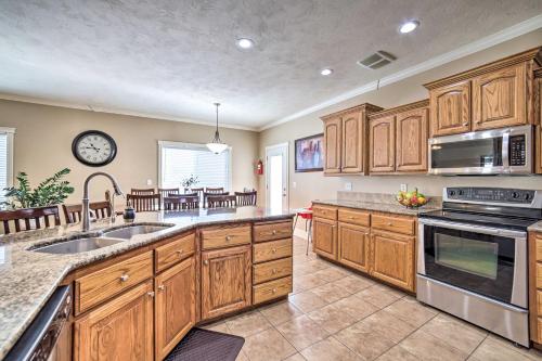 a large kitchen with wooden cabinets and a sink at Spacious Idaho Home Ski, Hike, and Fish! in Rexburg