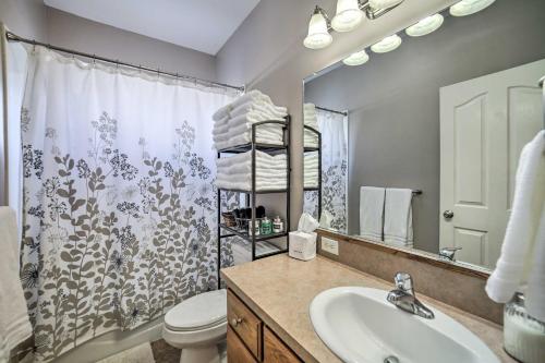 a bathroom with a sink and a toilet and a mirror at Spacious Idaho Home Ski, Hike, and Fish! in Rexburg