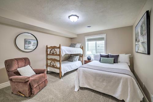 a bedroom with two beds and a chair and a mirror at Spacious Idaho Home Ski, Hike, and Fish! in Rexburg