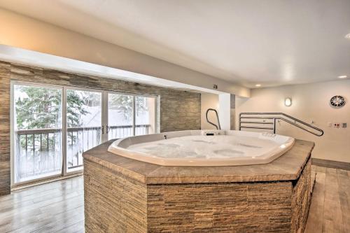 a large bath tub in a room with a large window at Remodeled Vail Condo with Hot Tub Access! in Vail