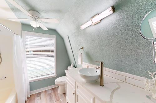 a bathroom with a sink and a toilet and a mirror at Sandy Toes in Rockport