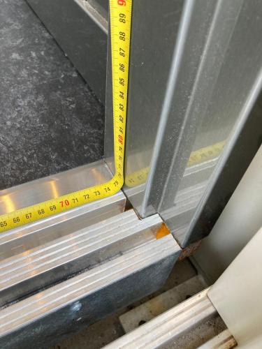a ruler next to a metal door with a window at Guest House Bella Onda in Tessera