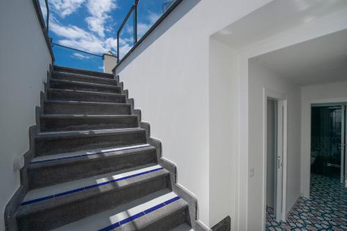 a staircase in a house with blue and white walls at La Perla di Nettuno in Furore