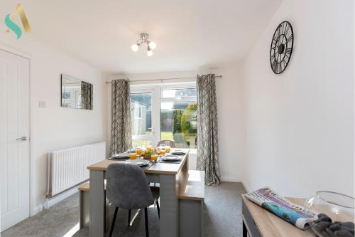 a living room with a dining room table and a dining room at Aberdovey House TSAC in Stockton-on-Tees