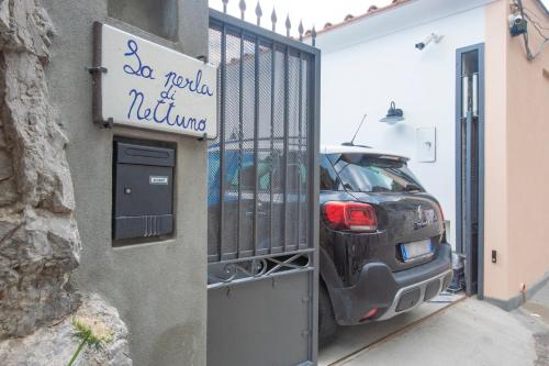 a car parked in a garage next to a building at La Perla di Nettuno in Furore