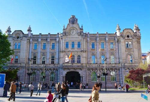 a large building with people walking in front of it at Santander centro in Santander