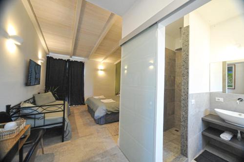 a bathroom with a sink and a bed in a room at Tenuta Bussete Country Hotel in Viterbo