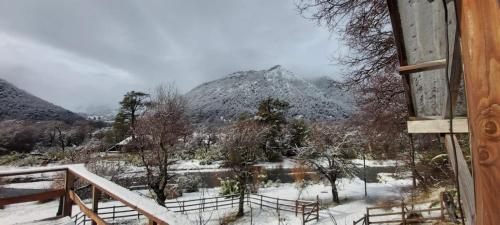 a view of a snow covered mountain from a house at Cabañas Estero Caracoles Malalcahuello in Malalcahuello