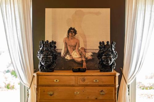 a dresser with a picture of a woman on it at CasaVostra - Ambience Suites in Ostra Vetere