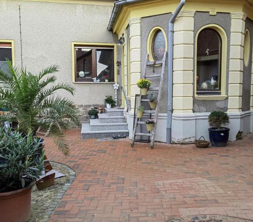 a house with a staircase on the side of it at Pension Claudia Güldenpfennig in Tangermünde