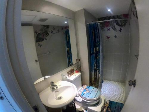 馬尼拉的住宿－Azure Urban Resort Staycation in Manila，一间带水槽、卫生间和镜子的浴室
