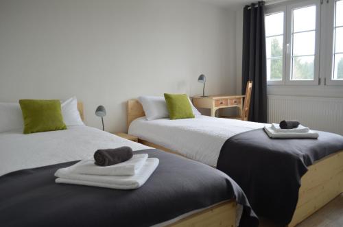 two beds in a room with towels on them at Hotel "Cafe Verkehrt" - Wellcome Motorbiker, Berufsleute und Reisende im Schwarzwald in Oberhof