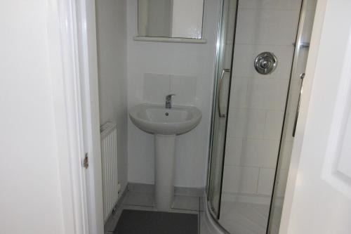 a bathroom with a sink and a shower at Churchill Hotel & Nagawa Restaurant in Coventry
