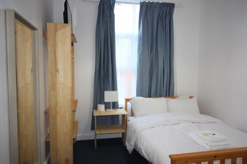 a bedroom with a bed and a window at Churchill Hotel & Nagawa Restaurant in Coventry