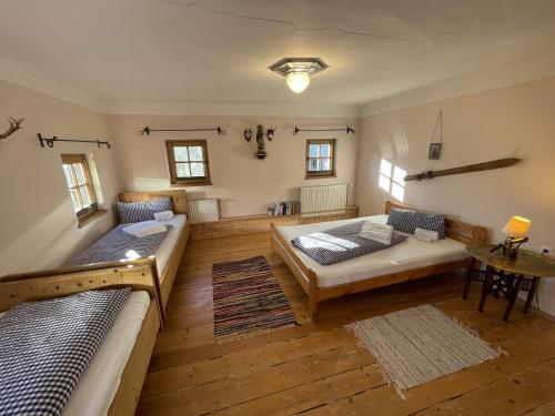 a living room with two beds and a table at Geigerhaus 500 Jahre - Appt A in Stuhlfelden