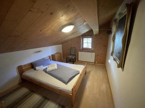 a small bedroom with a bed in a attic at Geigerhaus 500 Jahre - Appt C in Stuhlfelden