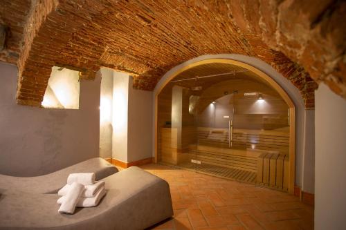 a bedroom with a bed in a room with a brick wall at Casual Rinascimento Firenze in Florence