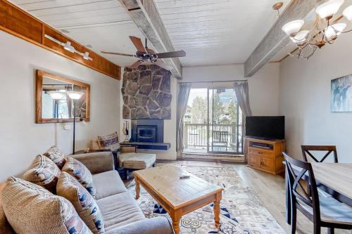 a living room with a couch and a table at Storm Meadows Slopeside Retreat in Steamboat Springs