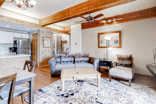 a living room with a couch and a table at Storm Meadows Slopeside Retreat in Steamboat Springs