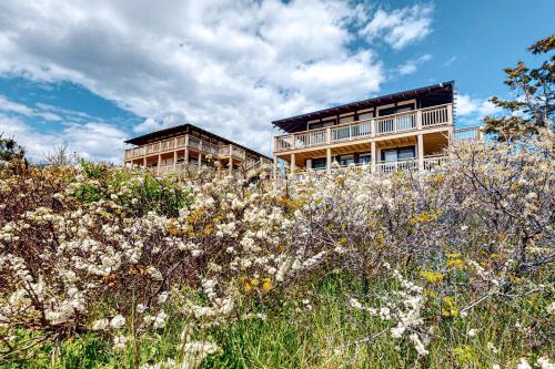 a building on top of a hill with white flowers at Ships Ahoy in Truro
