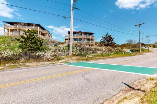 an empty street with a building and a tennis court at Ships Ahoy in Truro