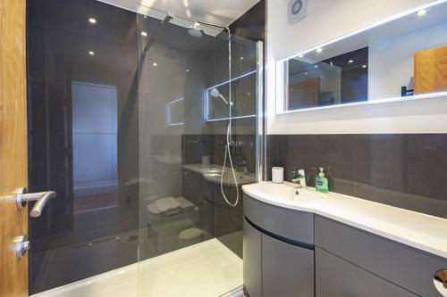a bathroom with a glass shower and a sink at Clearwater 74, Goldcrest P in Somerford Keynes