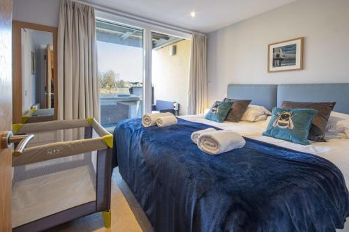 a bedroom with two beds with towels on them at Clearwater 74, Goldcrest P in Somerford Keynes