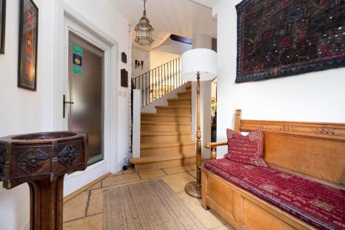 a living room with a bench and a staircase at Strathendrick House Magnificent property with Garden in Drymen