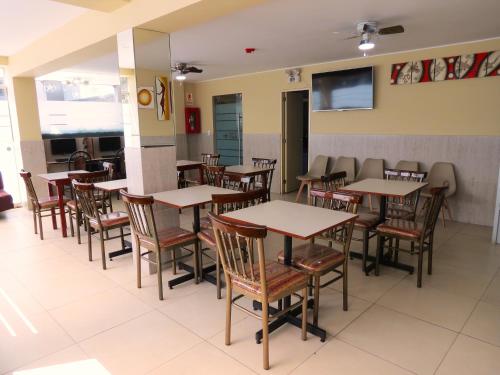 a dining room with wooden tables and chairs at HOTEL ESTRELLA in Lima