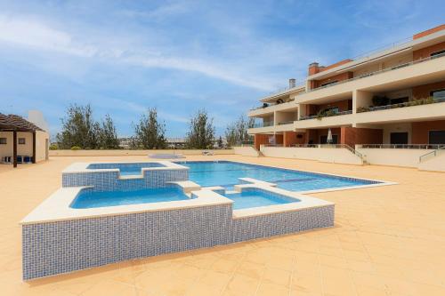 a swimming pool in front of a building at Arco-Iris in Lagos