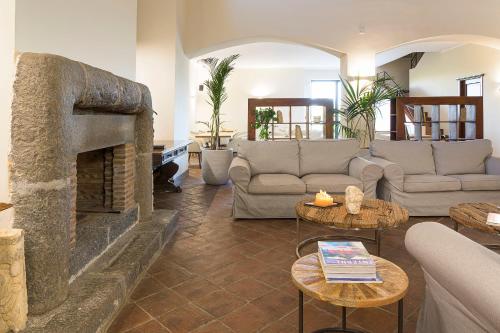 a living room with a couch and a fireplace at Nèroli Bio Relais in Catania