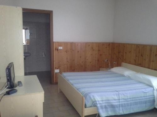 En eller flere senge i et værelse på Hotel Ticino Ristorante Chierico