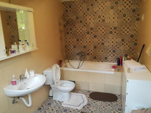 een badkamer met een toilet, een wastafel en een bad bij Brvnara Aleksic in Kraljevo